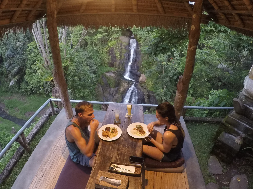 Eating at restaurant with view of waterfall at Layana Warung near Ubud